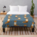 Plush blanket featuring a pattern of foxes in an autumn forest scene
