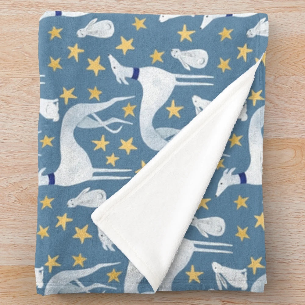 Plush blanket featuring a design with a galgo, hares, and stars