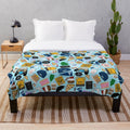 Plush blue blanket with all-over print of Gilmore fan patterns