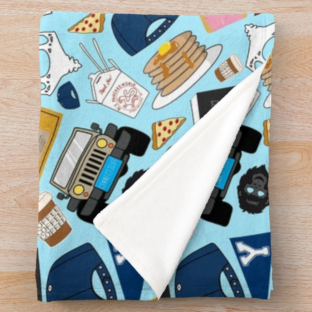 Plush blue blanket with all-over print of Gilmore fan patterns