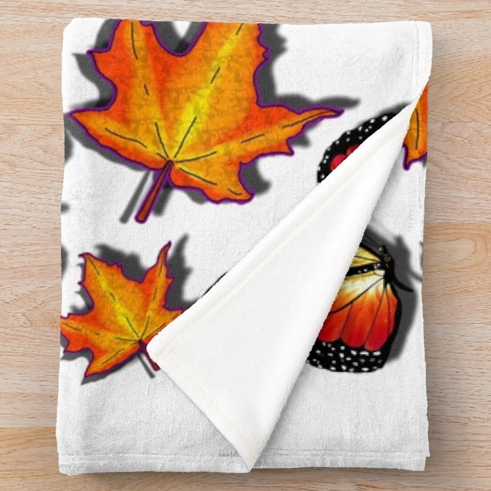 Plush blanket featuring monarch butterflies and vibrant orange fall leaves