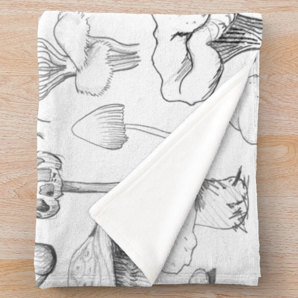 Soft, grey plush blanket with a whimsical mushroom pattern design
