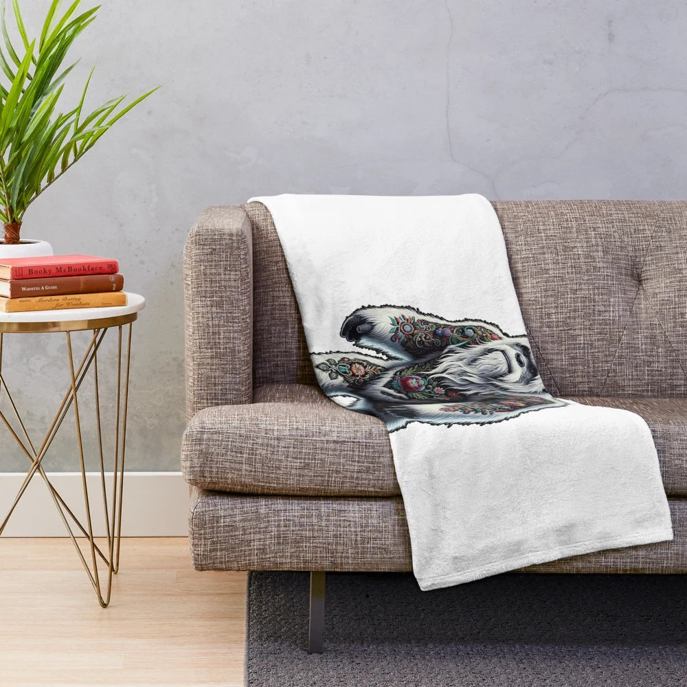 Plush blanket featuring an embroidered mythical creature design