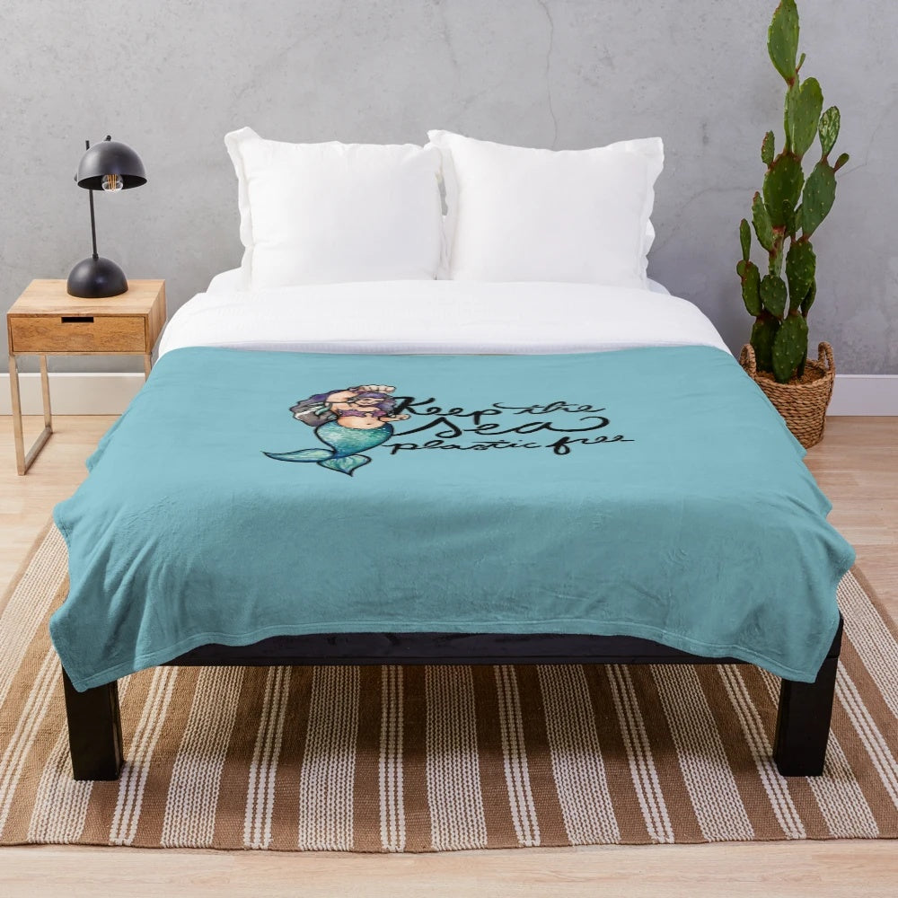 Soft and cuddly plush blanket featuring a marine life design, promoting plastic-free living.