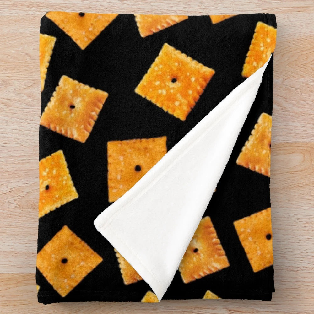 Plush black blanket with an orange square snack pattern design