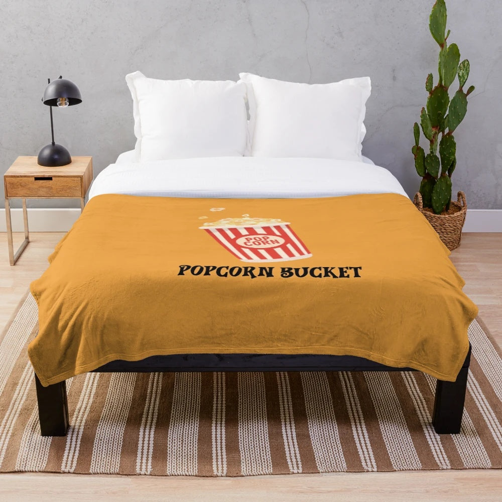 Plush blanket with a popcorn bucket design, perfect for movie night or snuggling