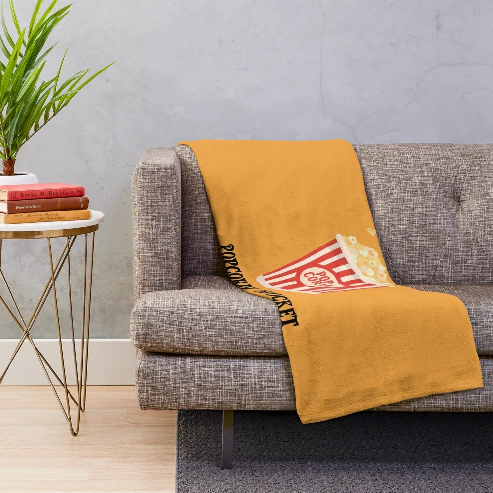 Plush blanket with a popcorn bucket design, perfect for movie night or snuggling