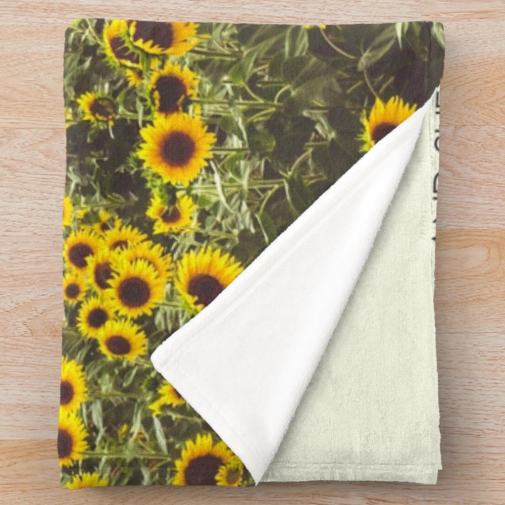 Plush blanket featuring a design with proverbs and sunflowers