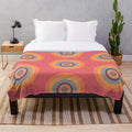 A cozy plush blanket featuring mesmerizing psychedelic fractal patterns.