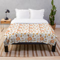 Cozy plush blanket with whimsical pumpkin patch design for fall home decor