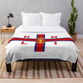 Plush blanket with coastal scene inspired by the Royal National Lifeboat Institution flag