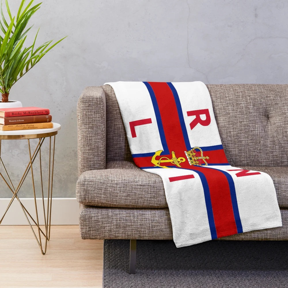 Plush blanket with coastal scene inspired by the Royal National Lifeboat Institution flag