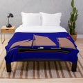 Plush blanket with sailing barge motif for nautical home decor