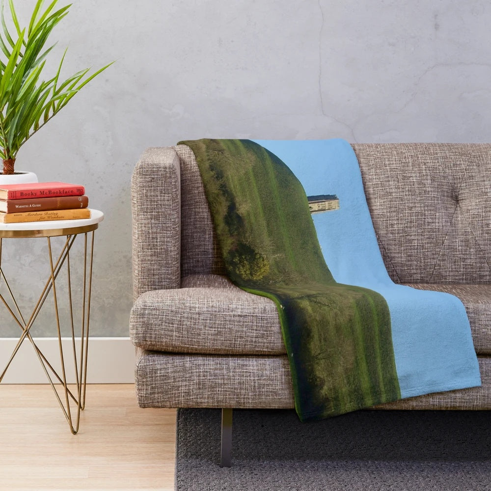 Plush blanket featuring sheep grazing in a countryside landscape at Glastonbury Tor