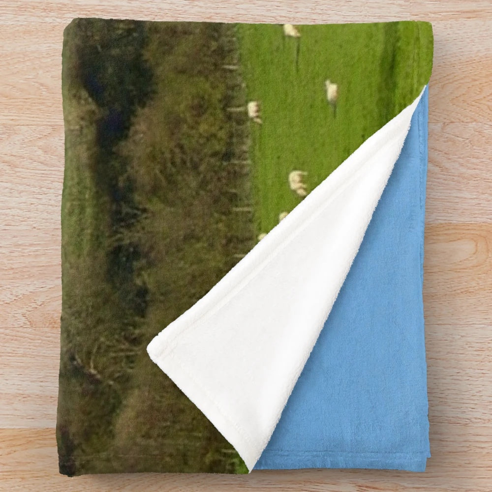 Plush blanket featuring sheep grazing in a countryside landscape at Glastonbury Tor