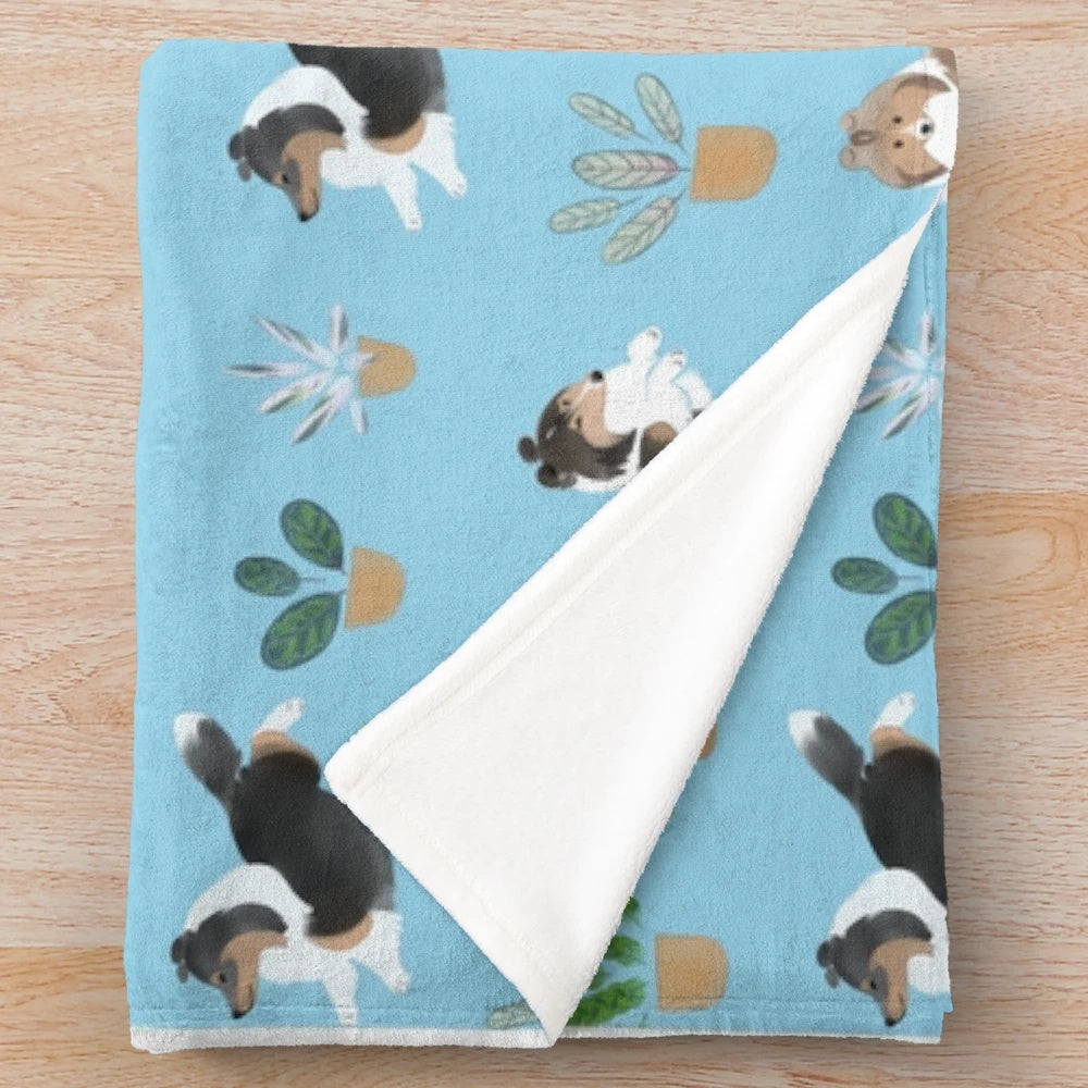 Soft and plush blue blanket featuring a Shetland sheepdog (sheltie) and a calathea house plant