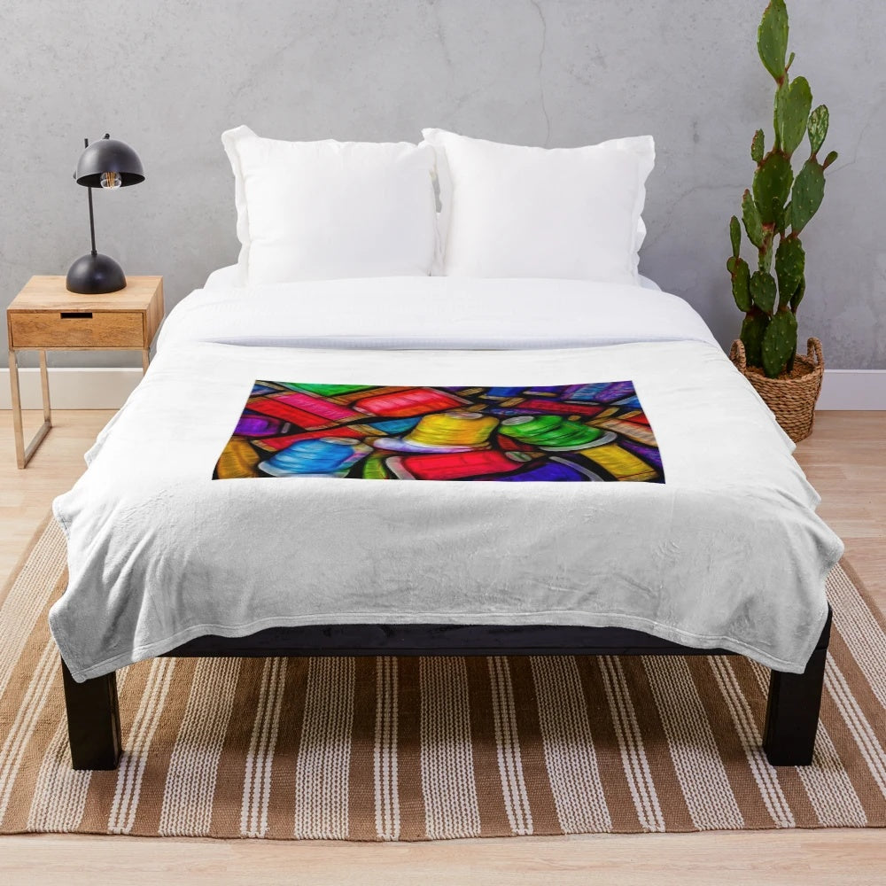 Plush blanket with intricately woven spools of thread design