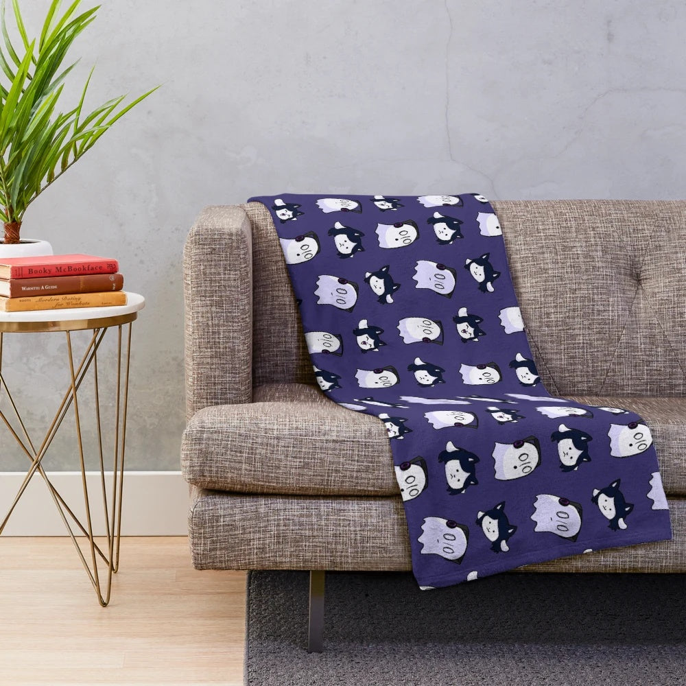 A soft and plush blanket featuring the characters Temmie and Napstablook from the popular video game Undertale.