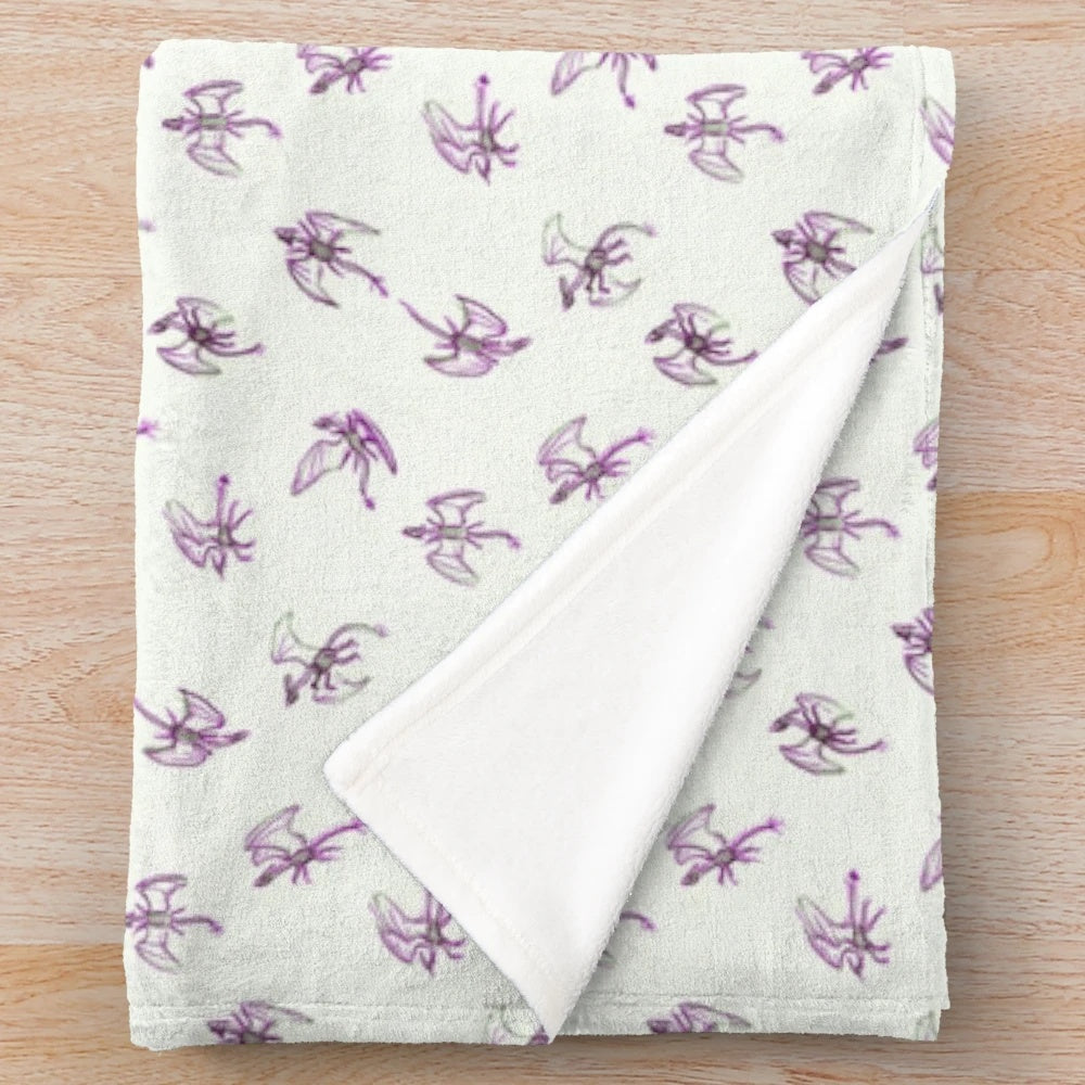 A plush blanket with a whimsical small dragon pattern design