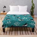 Plush blanket featuring a puffin swimming underwater in an arctic ocean scene