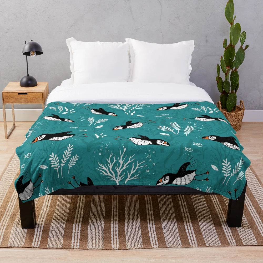 Plush blanket featuring a puffin swimming underwater in an arctic ocean scene