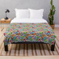 Cozy plush blanket featuring a vibrant abstract pattern with cartoon animals and fruits