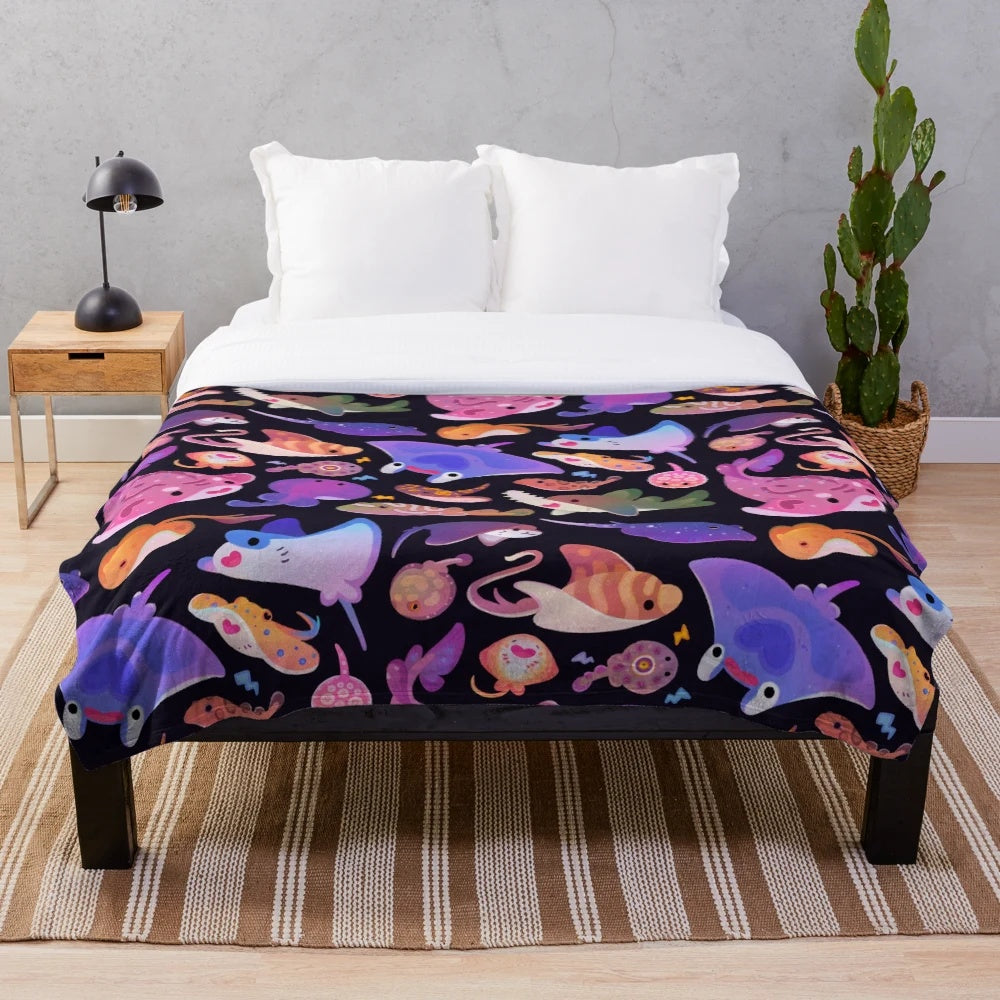 Plush blanket featuring a vibrant design of various ray and marine life species
