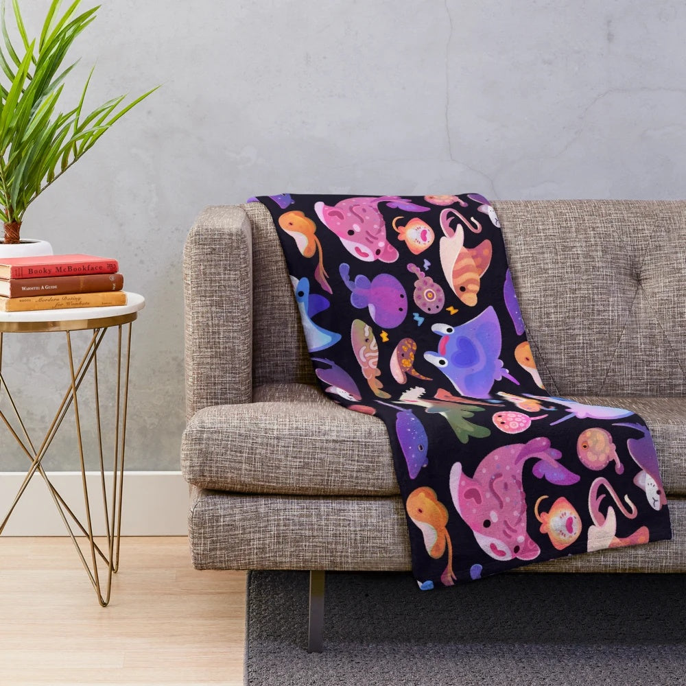 Plush blanket featuring a vibrant design of various ray and marine life species