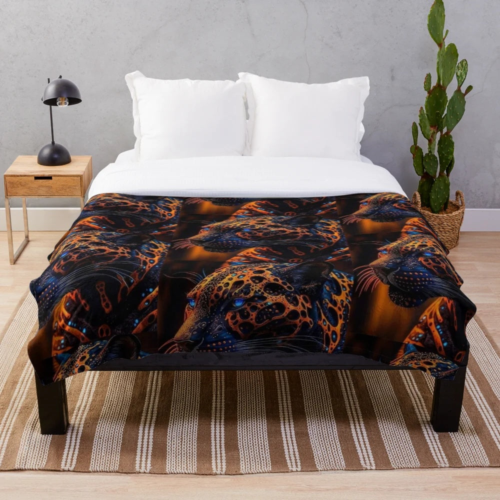 Plush blanket with navy blue, orange, and yellow patterned lion figure