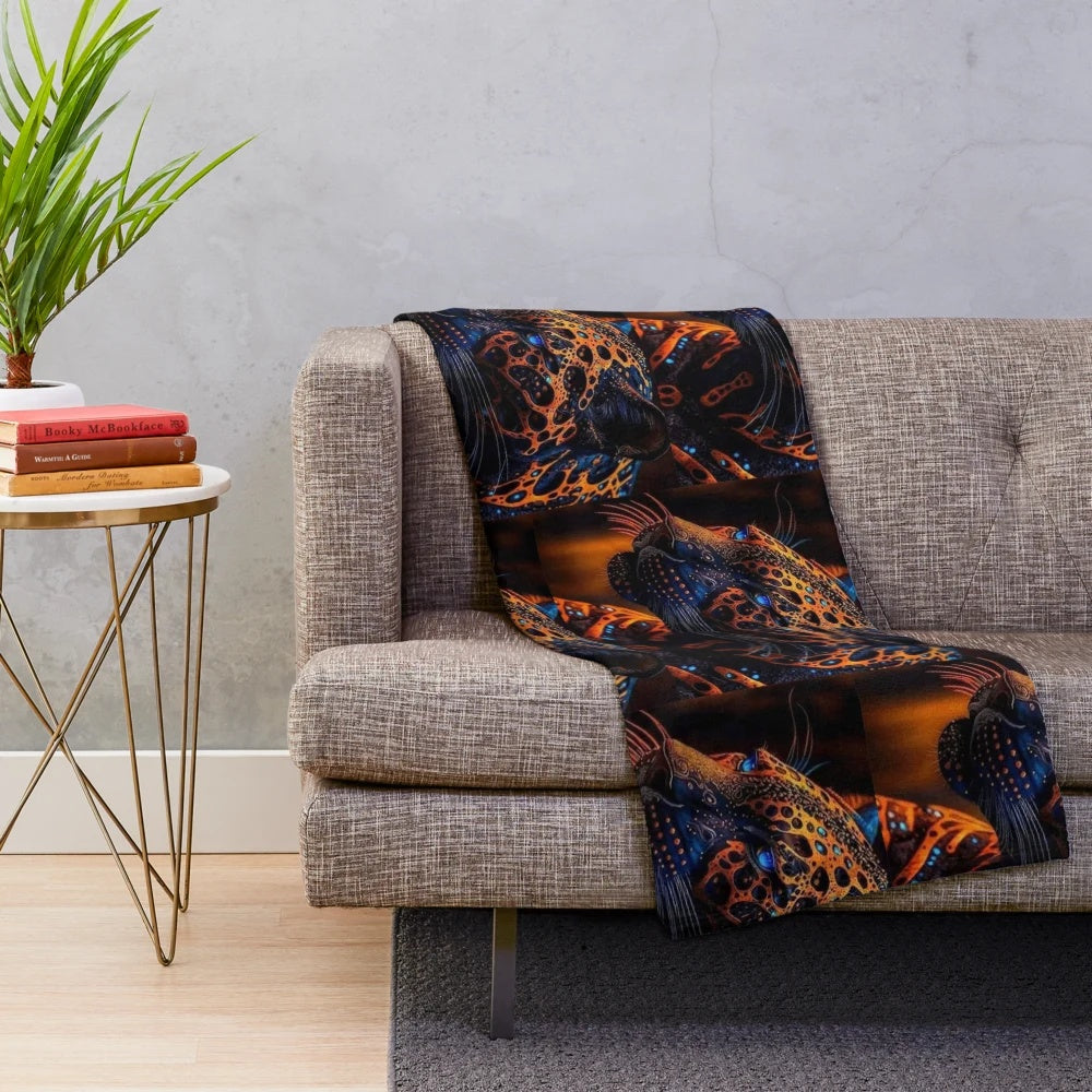 Plush blanket with navy blue, orange, and yellow patterned lion figure