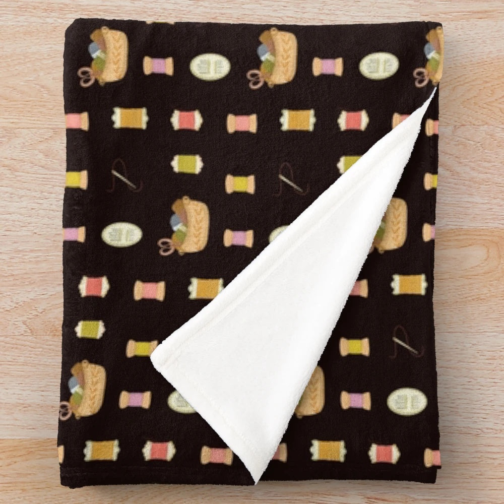 Colorful plush blanket featuring sewing-themed design