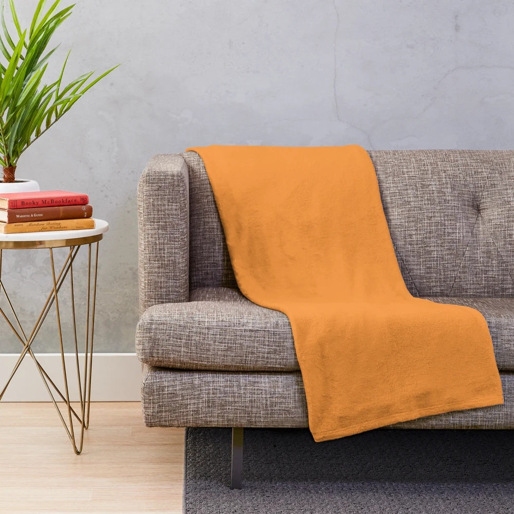 Warm orange watercolor flowers on a cozy plush blanket