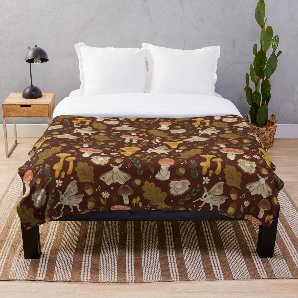 Cozy plush blanket featuring a whimsical mushroom and nature-inspired pattern