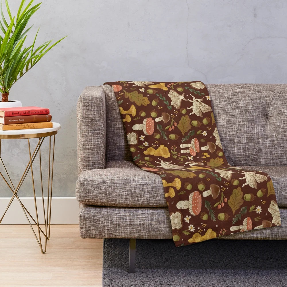 Cozy plush blanket featuring a whimsical mushroom and nature-inspired pattern