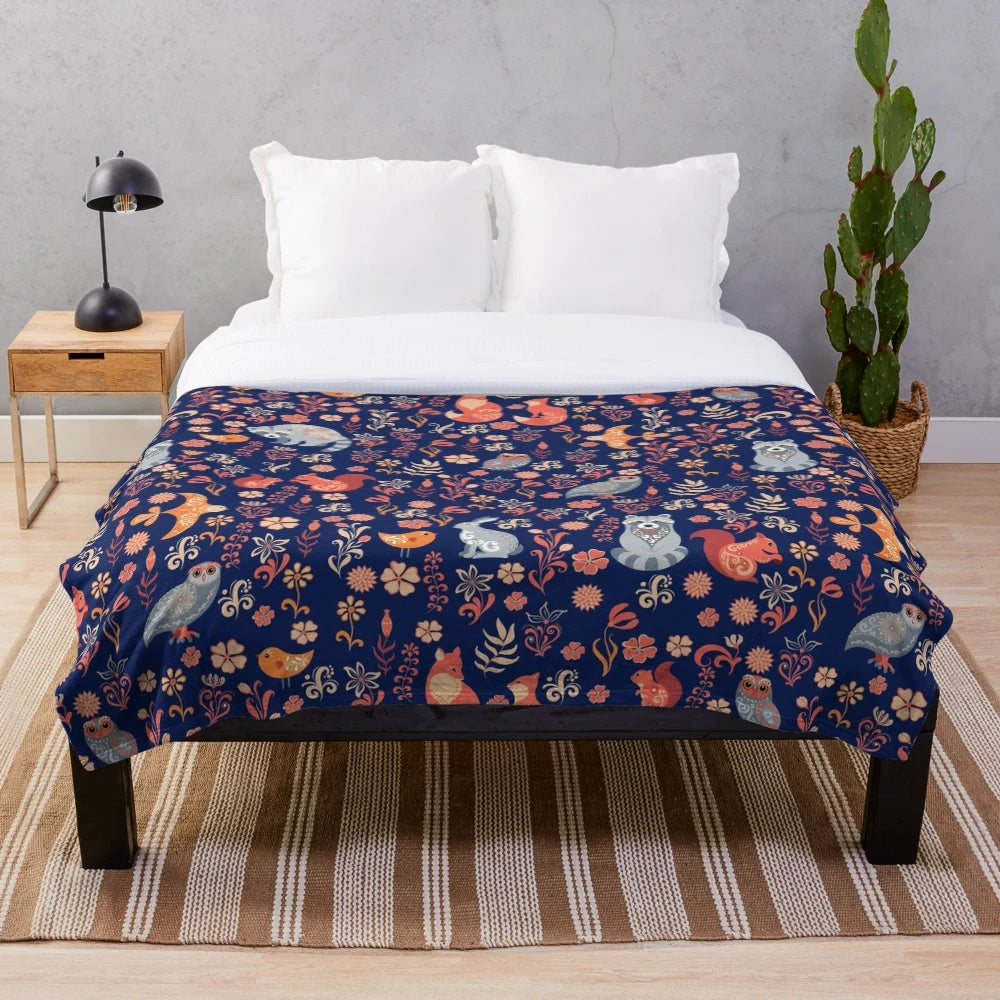 Plush blanket with a seamless pattern featuring a fairy-tale forest with cute cartoon animals like fox, bear, raccoon, owls, and rabbits