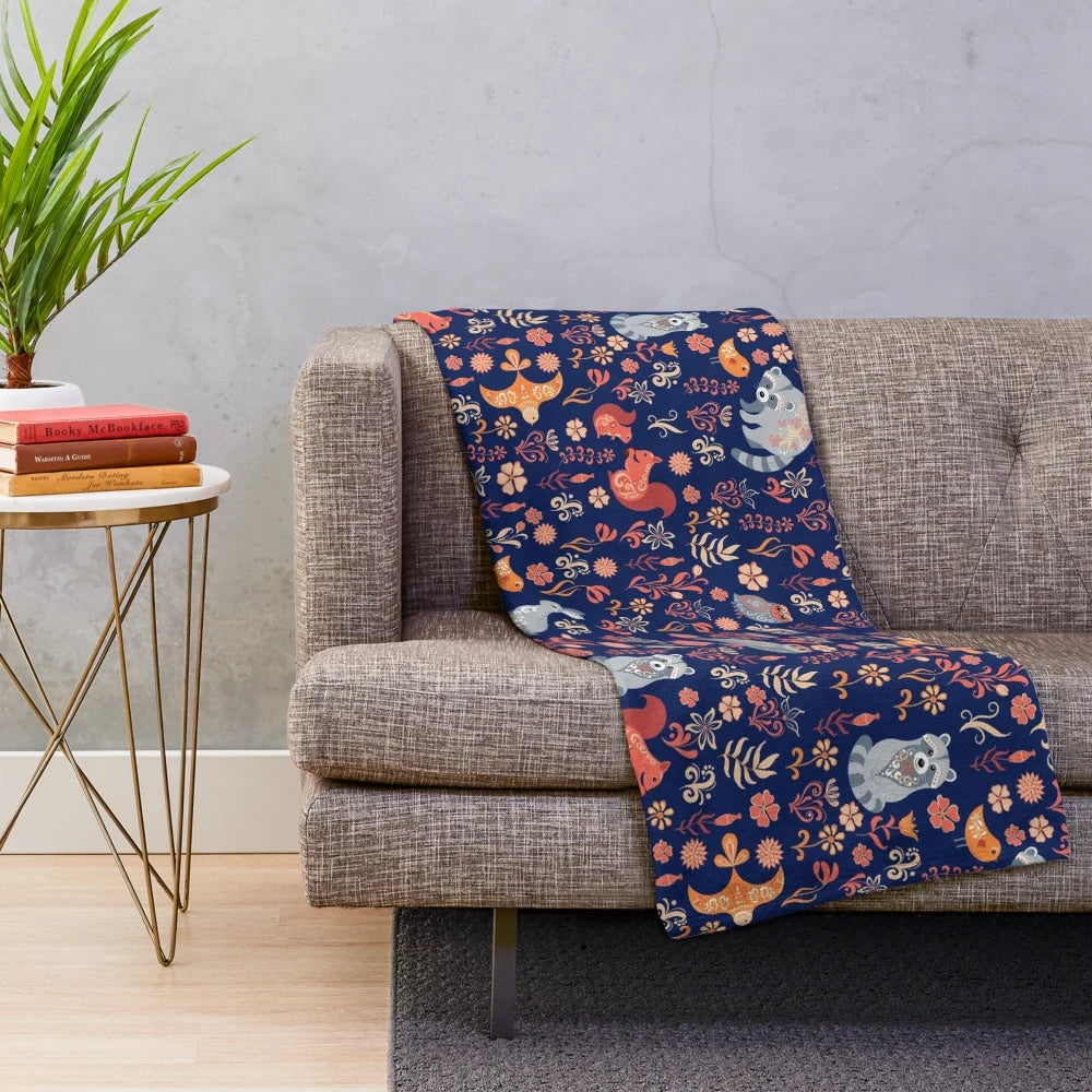 Plush blanket with a seamless pattern featuring a fairy-tale forest with cute cartoon animals like fox, bear, raccoon, owls, and rabbits