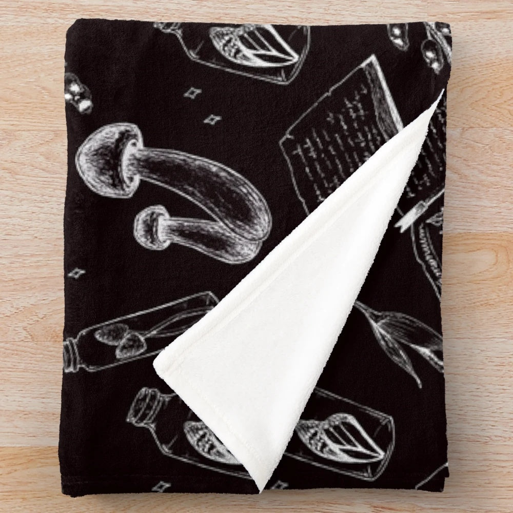Cozy plush blanket with a witchy mushroom pattern design