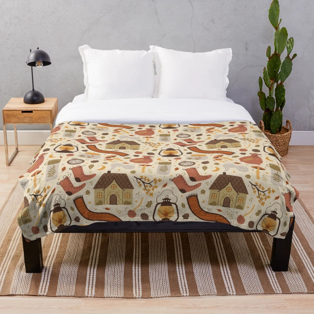 Plush blanket with nature-inspired pattern featuring woods, leaves, and acorns
