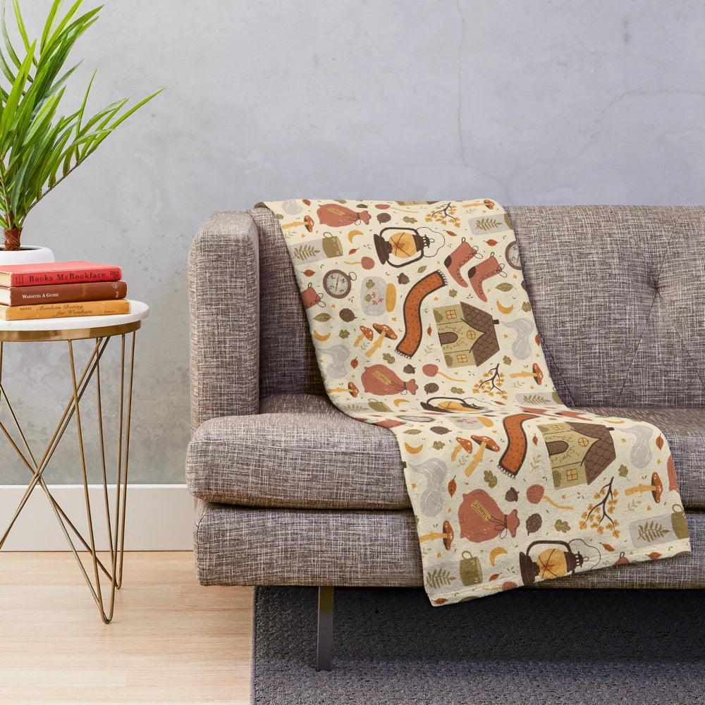 Plush blanket with nature-inspired pattern featuring woods, leaves, and acorns