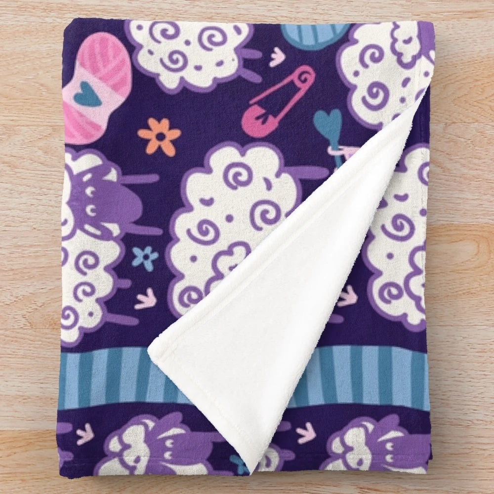 Soft and plush blanket featuring a woolly sheep and knitting design