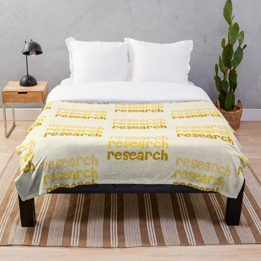 Plush blanket with yellow aesthetic and research-themed lettering