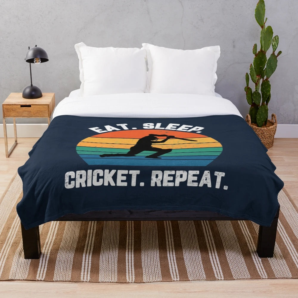 Plush blanket with "Eat Sleep Cricket Repeat" sunset graphic design