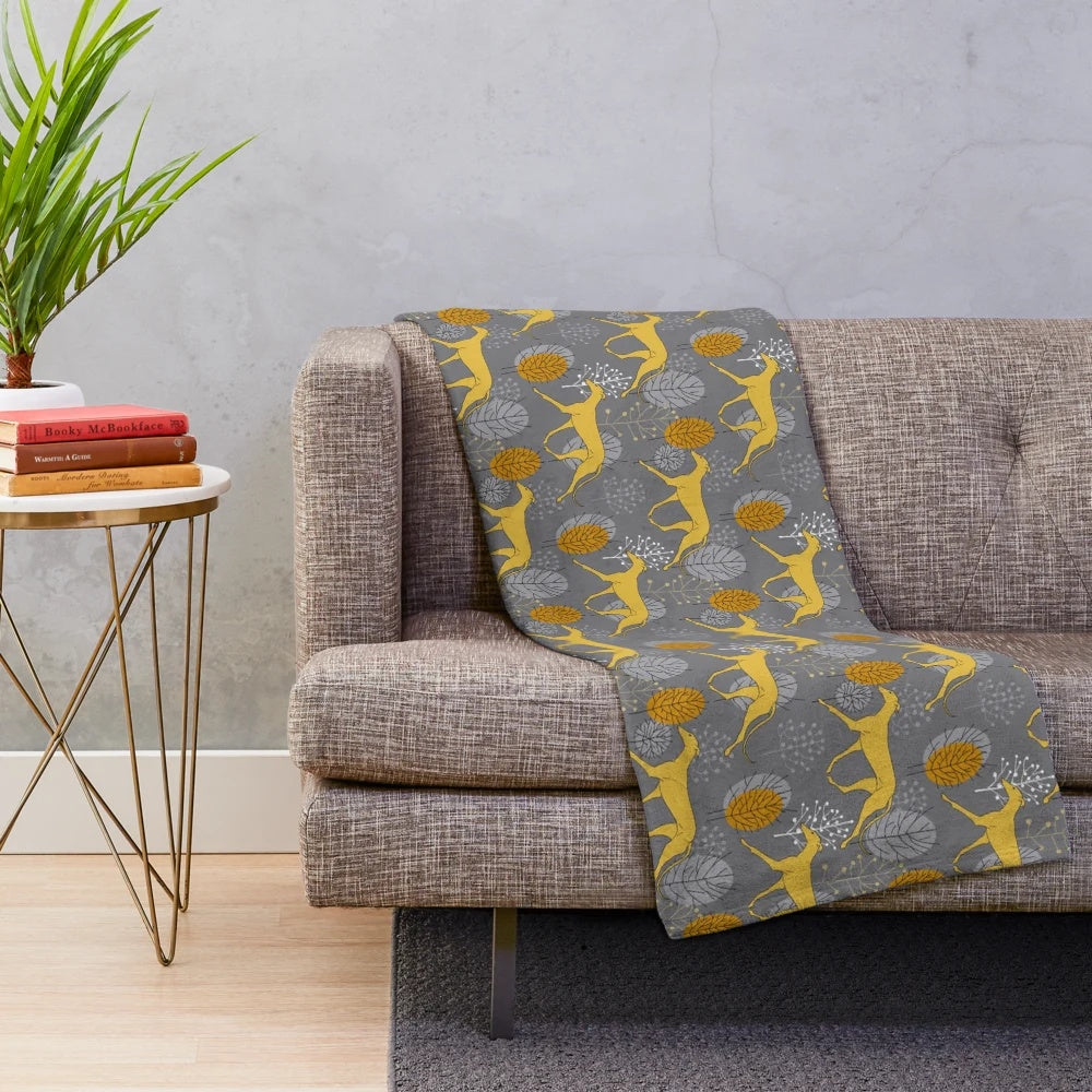Cozy plush blanket featuring a design of trotting yellow galgos