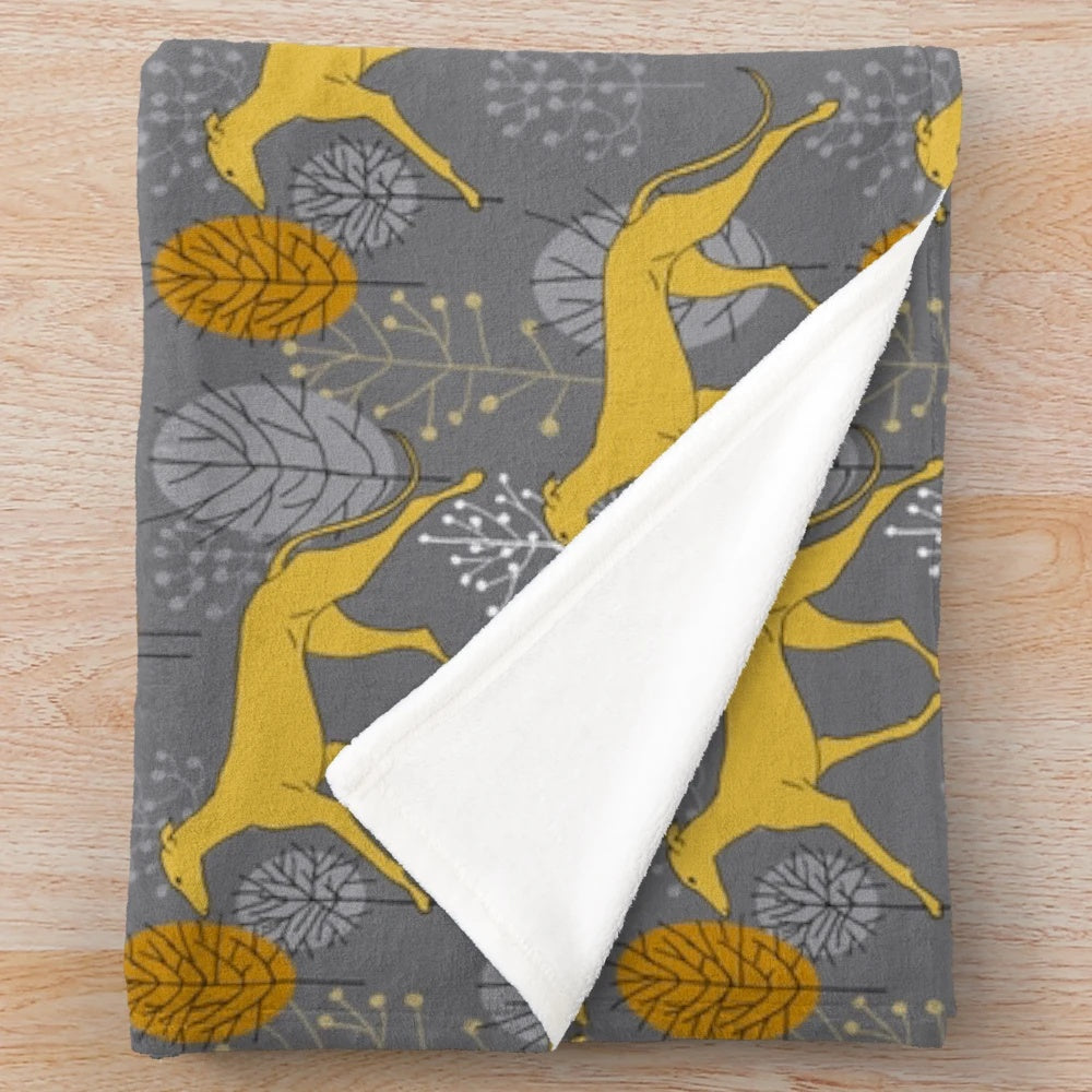 Cozy plush blanket featuring a design of trotting yellow galgos
