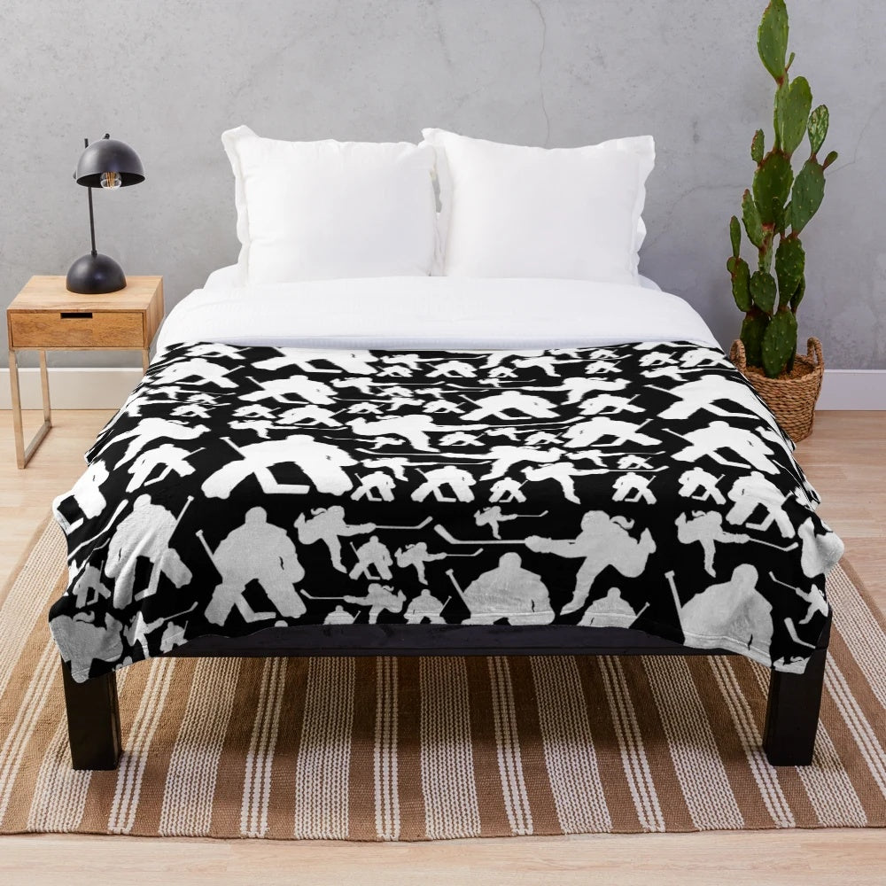 Plush hockey-themed blanket with a patterned design featuring hockey players and equipment