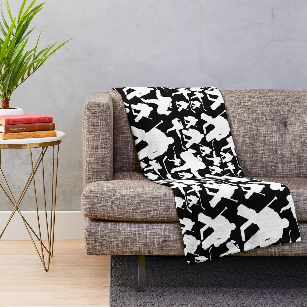 Plush hockey-themed blanket with a patterned design featuring hockey players and equipment