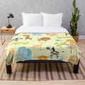 Plush jungle animals blanket featuring elephant, giraffe, and other wildlife