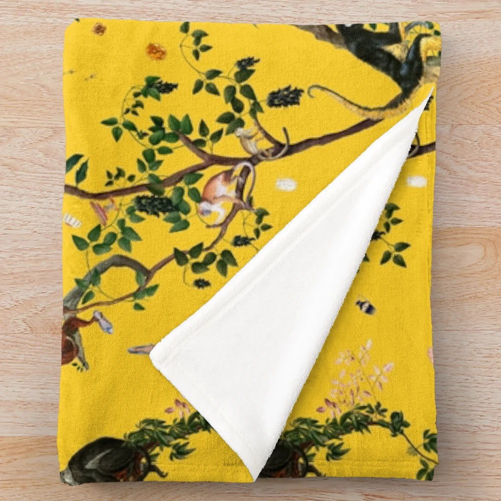 Soft and plush yellow floral monkey-patterned blanket