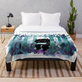 Soft and cozy plush blanket featuring a watercolor monster design, perfect for book lovers.