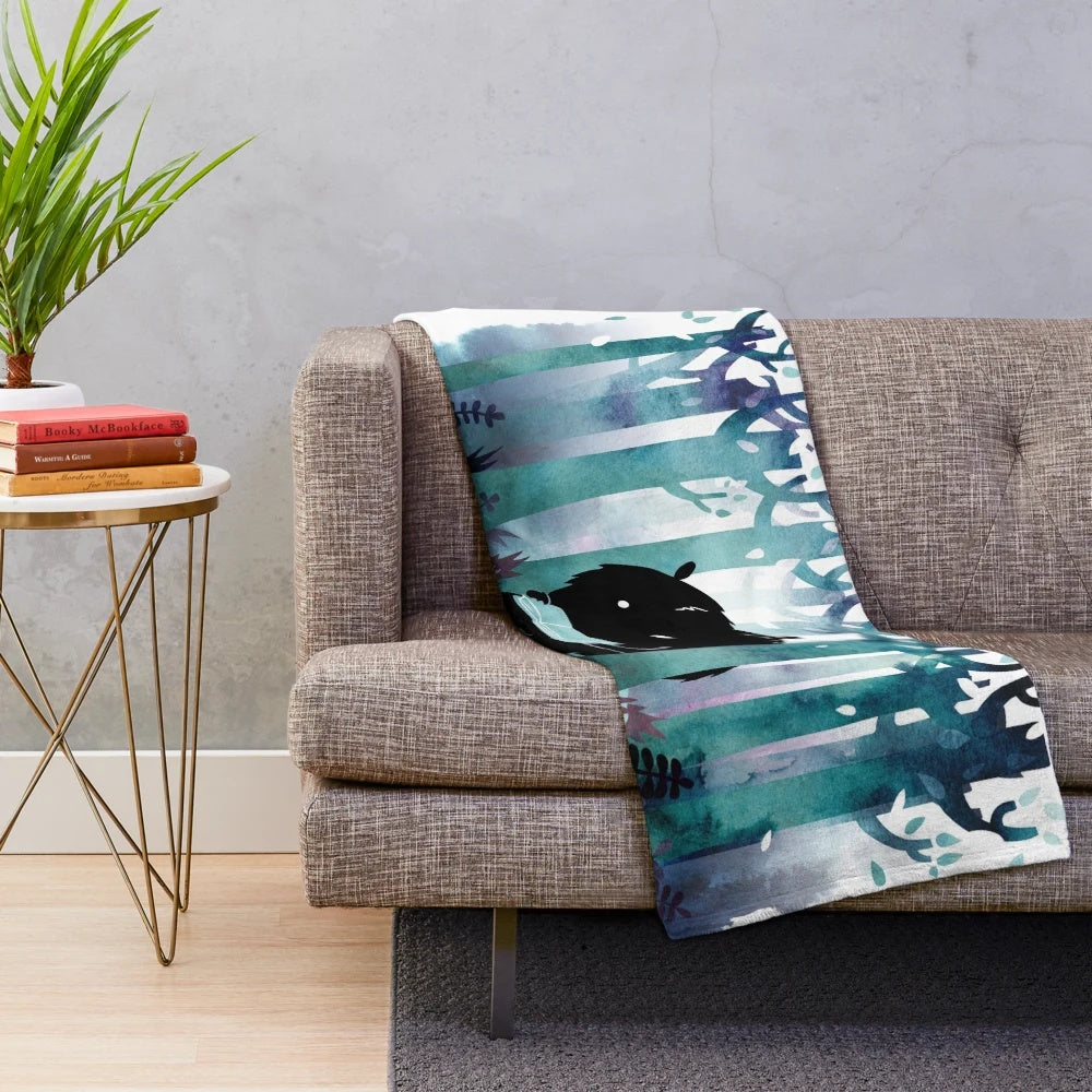 Soft and cozy plush blanket featuring a watercolor monster design, perfect for book lovers.